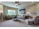 Cozy living room with comfortable seating, soft carpet, and ample natural light at 1005 Keith Rd, Wake Forest, NC 27587