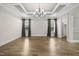 Bright living room with hardwood floors, coffered ceilings, and natural light at 1005 Keith Rd, Wake Forest, NC 27587