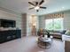 Relaxing living room with a large sectional sofa, a TV, and soft, neutral décor at 1005 Keith Rd, Wake Forest, NC 27587