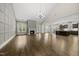 Spacious living room with fireplace, hardwood floors, and vaulted ceiling open to the modern kitchen at 1005 Keith Rd, Wake Forest, NC 27587