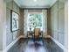 Office features a modern desk with natural light and wainscoting at 1005 Keith Rd, Wake Forest, NC 27587