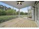Covered porch with wood flooring offers a serene outdoor living space with views of a lush backyard at 1005 Keith Rd, Wake Forest, NC 27587