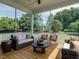 Screened-in porch featuring wicker furniture and a view of the backyard at 1005 Keith Rd, Wake Forest, NC 27587