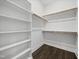 Walk-in closet with custom shelving and wood-look flooring at 1005 Keith Rd, Wake Forest, NC 27587