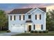 Two-story home featuring gray siding, black shutters, a two-car garage and manicured lawn at 1017 Freestone Rd, Durham, NC 27703