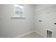 A simple, clean, and bright laundry room with a window and modern flooring at 1017 Freestone Rd, Durham, NC 27703