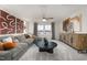 A spacious loft with an oversized gray couch, ceiling fan, neutral walls, large windows and modern decor at 1017 Freestone Rd, Durham, NC 27703