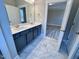 Modern bathroom featuring a double sink vanity, marble tile floors, and white cabinets at 1063 Fairhaven Dr # 54, Mebane, NC 27302