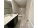 Bright bathroom featuring vanity with sink, quartz counters, tile floors, and tub/shower at 1063 Fairhaven Dr # 54, Mebane, NC 27302