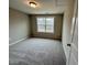 Carpeted bedroom featuring natural light from the window and neutral paint at 1063 Fairhaven Dr # 54, Mebane, NC 27302