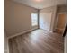 Bright bedroom featuring wood floors, trim, and natural light from the window at 1063 Fairhaven Dr # 54, Mebane, NC 27302