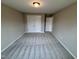 A clean and simple bedroom with neutral walls, carpet, and white closet doors at 1063 Fairhaven Dr # 54, Mebane, NC 27302