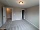 Bedroom with a carpet flooring, neutral paint and trim, a window, and access to other spaces at 1063 Fairhaven Dr # 54, Mebane, NC 27302