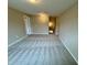 This bonus room features neutral walls, carpet, and access to the stairwell at 1063 Fairhaven Dr # 54, Mebane, NC 27302