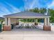 Community picnic shelter with multiple picnic tables and trashcans at 1063 Fairhaven Dr # 54, Mebane, NC 27302