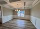 This dining room features coffered ceilings, chair rail, and hardwood floors at 1063 Fairhaven Dr # 54, Mebane, NC 27302