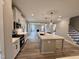 Open-concept kitchen features white cabinets, quartz countertops and stainless appliances flowing into the living space at 1063 Fairhaven Dr # 54, Mebane, NC 27302