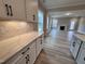 Kitchen featuring white cabinets, subway tile backsplash, and quartz countertops at 1063 Fairhaven Dr # 54, Mebane, NC 27302