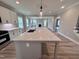 This kitchen features stainless appliances, white cabinets, a center island and an open layout to the living area at 1063 Fairhaven Dr # 54, Mebane, NC 27302