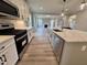 Modern kitchen showcasing stainless steel appliances, quartz countertops, and seamless integration with the living area at 1063 Fairhaven Dr # 54, Mebane, NC 27302