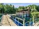 A cozy lake house on a pier with a rustic exterior, nestled on a tranquil lake and surrounded by lush trees at 1063 Fairhaven Dr # 54, Mebane, NC 27302