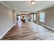 Spacious living room with wood floors and large windows, leading into an open kitchen area at 1063 Fairhaven Dr # 54, Mebane, NC 27302
