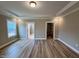 Spacious main bedroom featuring wood floors, trey ceiling, and closet space at 1063 Fairhaven Dr # 54, Mebane, NC 27302