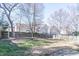Backyard featuring a wood fence, brick border, and mature trees at 117 Crabwall Ct, Holly Springs, NC 27540