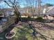Backyard featuring a wood fence, brick border, and mature trees at 117 Crabwall Ct, Holly Springs, NC 27540