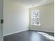 Bedroom featuring natural light, gray wood floors, and neutral paint at 117 Crabwall Ct, Holly Springs, NC 27540
