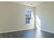Bedroom featuring natural light, gray wood floors, and neutral paint at 117 Crabwall Ct, Holly Springs, NC 27540