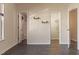 Bright bedroom featuring gray wood floors, neutral walls, and shelving at 117 Crabwall Ct, Holly Springs, NC 27540