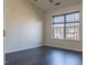 Comfortable bedroom with hardwood floors, large window, and ample natural light at 117 Crabwall Ct, Holly Springs, NC 27540