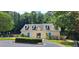 Exterior of the community clubhouse with blue trim and mature trees in the background at 117 Crabwall Ct, Holly Springs, NC 27540