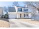 Charming two-story home featuring a front porch, attached garage, and well-maintained landscaping at 117 Crabwall Ct, Holly Springs, NC 27540