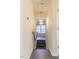 Hallway featuring gray wood floors and a modern light fixture at 117 Crabwall Ct, Holly Springs, NC 27540