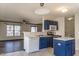 Open kitchen with stainless steel appliances, ample counter space, and views of the dining area at 117 Crabwall Ct, Holly Springs, NC 27540