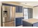 Well-equipped kitchen featuring an island, stainless steel refrigerator, and plenty of storage space at 117 Crabwall Ct, Holly Springs, NC 27540