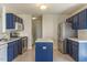 Functional kitchen with stainless steel appliances, center island, and tile flooring at 117 Crabwall Ct, Holly Springs, NC 27540