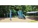 Playground with a slide, monkey bars, and swings surrounded by trees at 117 Crabwall Ct, Holly Springs, NC 27540