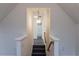 A carpeted staircase descends, leading to a bathroom with tiled floors and a bathtub at 117 Crabwall Ct, Holly Springs, NC 27540