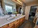 Bright bathroom featuring double sinks, a large mirror, a walk-in shower, and a separate soaking tub for ultimate relaxation at 1317 Justin Oaks Ct, Willow Springs, NC 27592