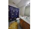 Bright bathroom features decorative shower curtain, gray floors and single sink vanity at 1317 Justin Oaks Ct, Willow Springs, NC 27592