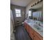 Bathroom featuring a double sink vanity, decorative window, and wood look flooring at 1317 Justin Oaks Ct, Willow Springs, NC 27592