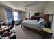 Cozy bedroom featuring a queen-sized bed, a ceiling fan, and a functional workspace, creating a relaxing and productive space at 1317 Justin Oaks Ct, Willow Springs, NC 27592