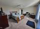 Spacious bedroom with a large bed, ceiling fan, and a functional desk area, perfect for comfort and productivity at 1317 Justin Oaks Ct, Willow Springs, NC 27592