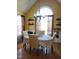 Cozy dining room with bright yellow walls, a chandelier, and a large arched window at 1317 Justin Oaks Ct, Willow Springs, NC 27592