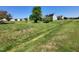 Residential home with a large lawn, trees, and installed solar panels, offering energy efficiency and environmental consciousness at 1317 Justin Oaks Ct, Willow Springs, NC 27592