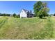 View of a well-maintained home from an angle showing the side and front, nestled on a beautifully landscaped lot at 1317 Justin Oaks Ct, Willow Springs, NC 27592