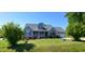 Charming home with a well-manicured lawn, flowering bushes, and a welcoming front porch, perfect for relaxing at 1317 Justin Oaks Ct, Willow Springs, NC 27592